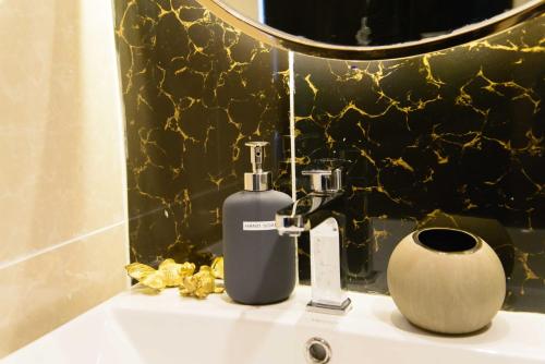 a bottle of soap sitting on top of a sink at 87 Oldtown at River Pier in Bangkok