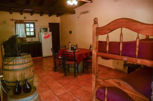 a room with a bed and a table and a kitchen at Posada San Vicente in San Rafael
