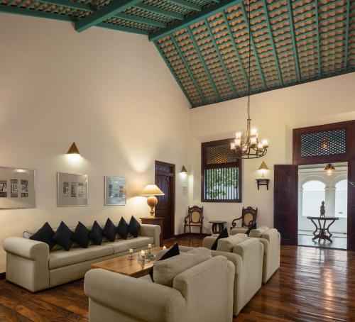 a living room with couches and a table at Green Casa in Galle