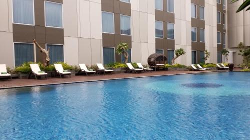 a swimming pool in front of a hotel at Radisson Lampung Kedaton in Bandar Lampung