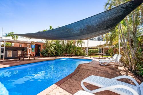 
a swimming pool with a surfboard on top of it at Karratha Central Apartments in Karratha
