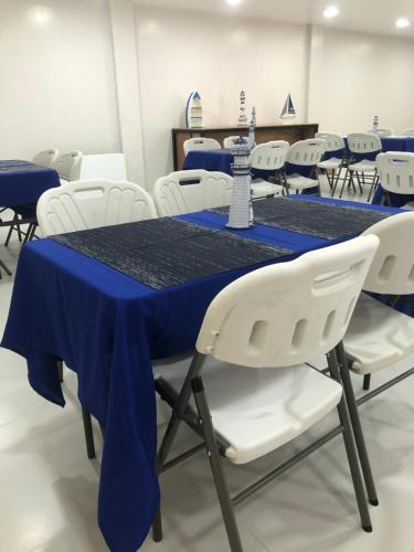 a conference room with a blue table and white chairs at South Anchorage Inn in El Nido