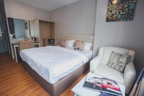 a small bedroom with a bed and a couch at V3 Hotel & Residence Seri Alam in Pasir Gudang