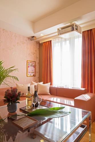 a living room with a couch and a glass table at Canon Himeji Higashi (Adult Only) in Himeji