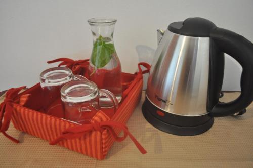 affeepot and a container with a drink in it next to a tea at Anjuna Hideout in Anjuna