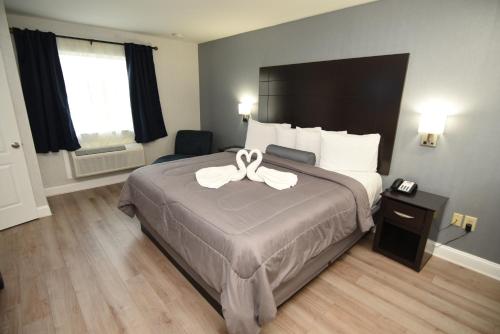 a hotel room with a bed with a bow on it at FairBridge Hotel Atlantic City in Galloway