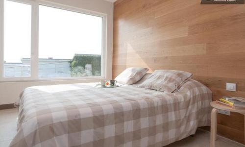 a bedroom with a bed with a table and a window at Alojamientos Montesal in Suances