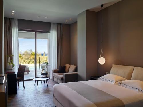 A bed or beds in a room at Pelagos Suites Hotel & Spa