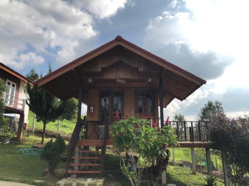 a small house with a porch and a deck at The Memory of Khaokho in Phetchabun