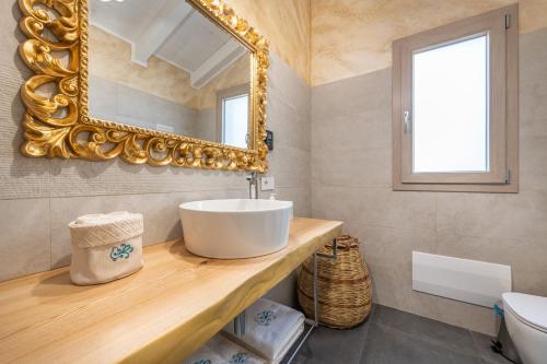 a bathroom with a sink and a mirror at Villa Sa Rocca Junior & Suite in Chia