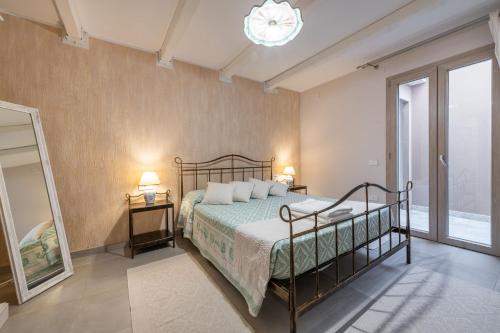 a bedroom with a bed and two lamps and a mirror at Villa Sa Rocca Manna in Chia