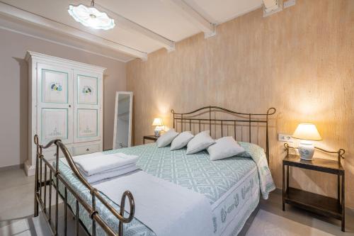 a bedroom with a large bed with white pillows at Villa Sa Rocca Manna in Chia