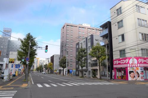an empty city street with a green traffic light at Hotel Classe Stay Sapporo in Sapporo