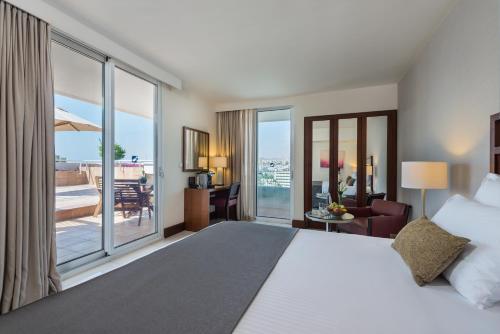 a hotel room with a bed and a view of the ocean at King Solomon by Isrotel Collection in Eilat
