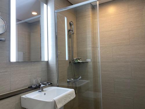 a bathroom with a sink and a shower at New Donghae Tourist Hotel in Donghae