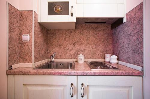 a kitchen with a sink and a counter at Apartments Villa Paradise in Kaštela
