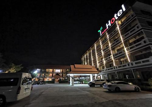 a hotel with cars parked in a parking lot at night at i Boutique Hotel in Pluak Daeng