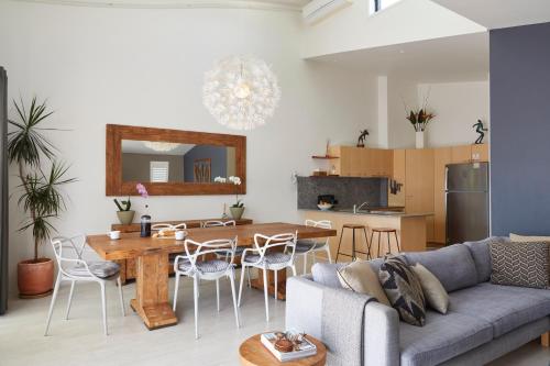 a living room with a couch and a table at Byron Quarter Apartments in Byron Bay