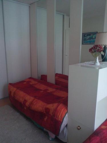 a bedroom with a bed and a dresser in it at Chambres d'hôtes Issy-Paris in Issy-les-Moulineaux