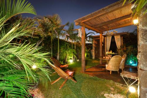 a garden with a wooden deck with a table and chairs at Nichochot Provence in Had Nes