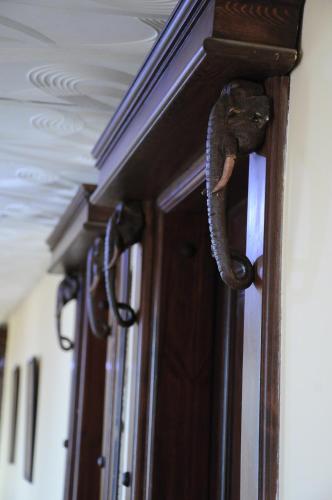 a door handle with a snake on the door at Africana Hotel & Spa in Borg El Arab