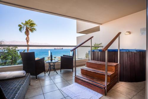 a house with a staircase and a view of the ocean at Aria in Eilat
