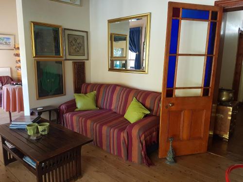 a living room with a couch and a table at Steytlerville Villa Guest house in Steytlerville