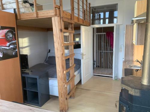 a loft bed in a room with a bedroom at Ferienwohnung Kaiserpanorama in Krumpendorf am Wörthersee