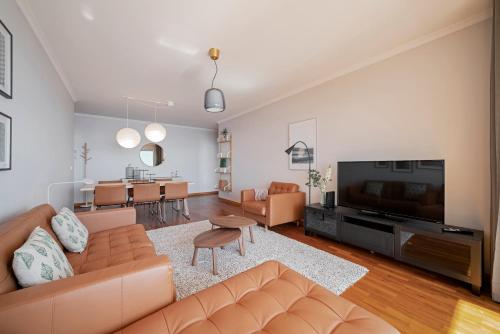 a living room with a couch and a television at Reis Magos III by An Island Apart in Caniço