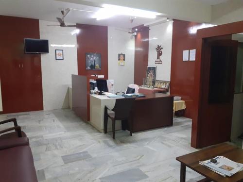 an office with a desk with a computer on it at Hotel Paradise Inn in Tiruppūr