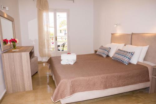 a bedroom with a large bed in a room at Erosea Beach Resort in Kavos