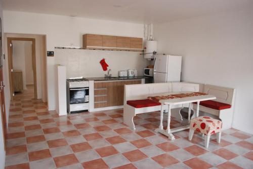 a kitchen with a table and a kitchen with a refrigerator at Amely in Esquel
