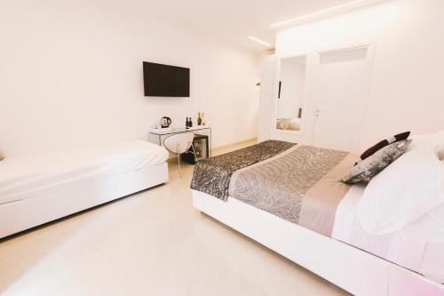a white bedroom with a bed and a sink at San Pietro Grand Suite in Rome