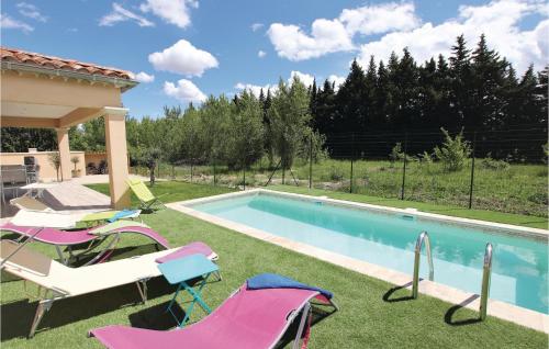 a backyard with a swimming pool with chairs and a gazebo at Stunning Home In Monteux in Monteux