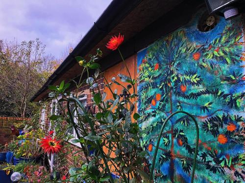 a painting on the side of a building with flowers at Caspian Hotel in London
