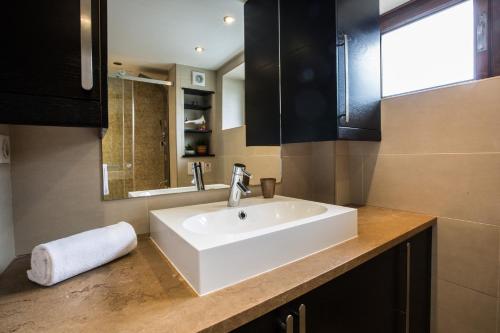 a bathroom with a white sink and a mirror at Apartment Germain 1 in Chamonix