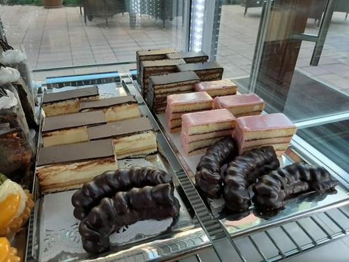 a display case with different types of meats and desserts at Jolán Pension & Restaurant in Číčov