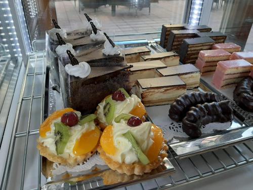 a display case with a bunch of desserts on display at Jolán Pension & Restaurant in Číčov
