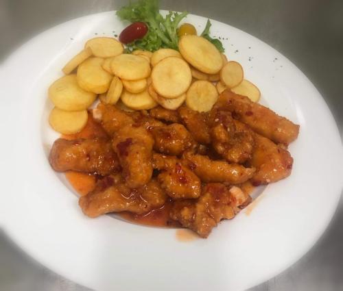 a plate of food with chicken and vegetables on it at Jolán Pension & Restaurant in Číčov