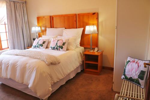 a bedroom with a large bed with a wooden headboard at Kairos Home in Middelburg