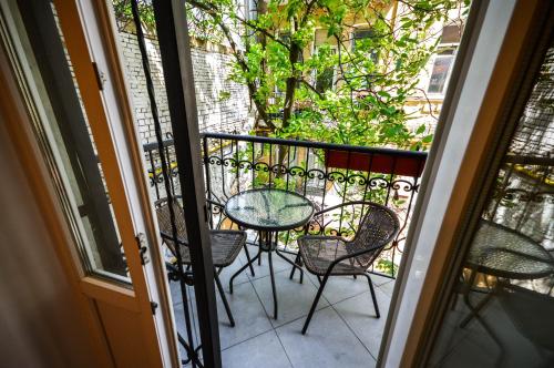 a patio with a table and chairs on a balcony at Kyiv Volcano Studio in Kyiv