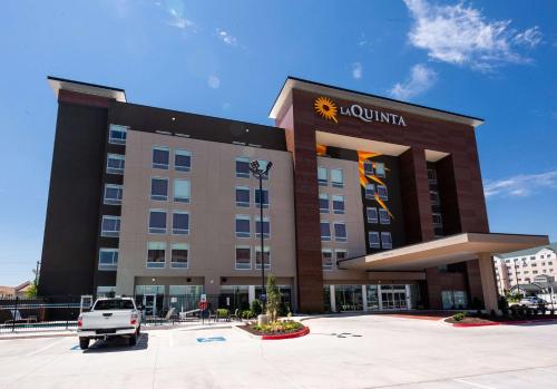 a hotel with a truck parked in front of it at La Quinta by Wyndham Oklahoma City Airport in Oklahoma City