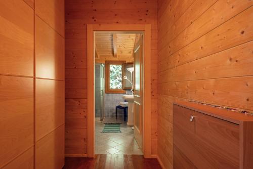 a hallway of a house with wooden walls and a bathroom at Chalet Scordapeni in Santa Maria di Licodia