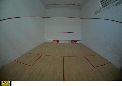 an empty gymnasium with a wooden basketball court at Royal Suite Caesarea in Caesarea