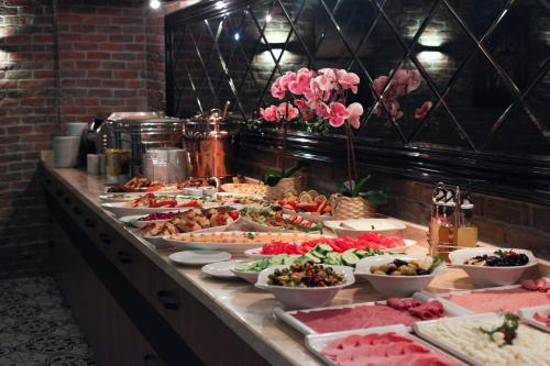 a buffet with many plates of food on a table at Pell Palace Hotel & SPA in Istanbul