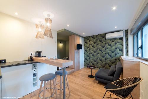 a kitchen and living room with a table and chairs at Studio Design Paloma Dark in Lyon
