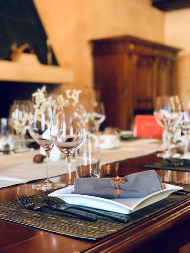 a table with wine glasses and a book on it at Villa Liverzano in Brisighella