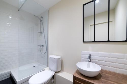 a bathroom with a toilet and a sink and a shower at Studio Design Paloma Dark in Lyon