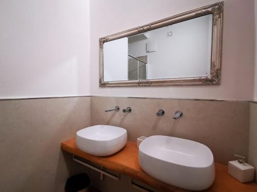 łazienka z białą umywalką i lustrem w obiekcie Deluxe 3 Bedroom Flat in Rialto w Wenecji