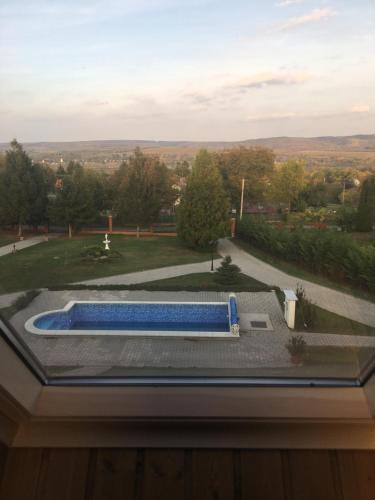 a view of a swimming pool from a window at Villa Teleki in Teleki